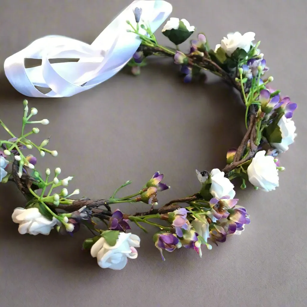 a flower crown of white and lilac artificial flowers