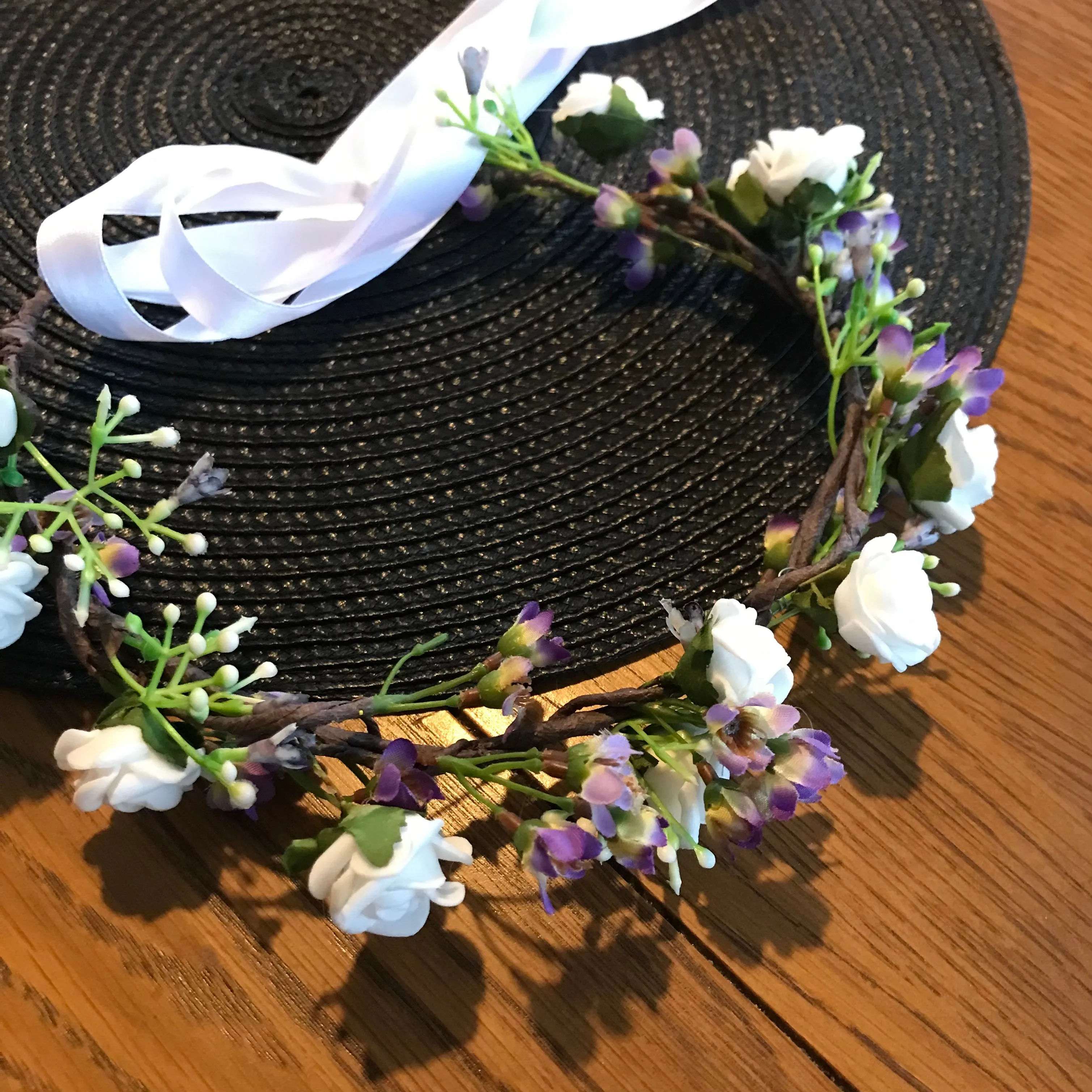 a flower crown of white and lilac artificial flowers