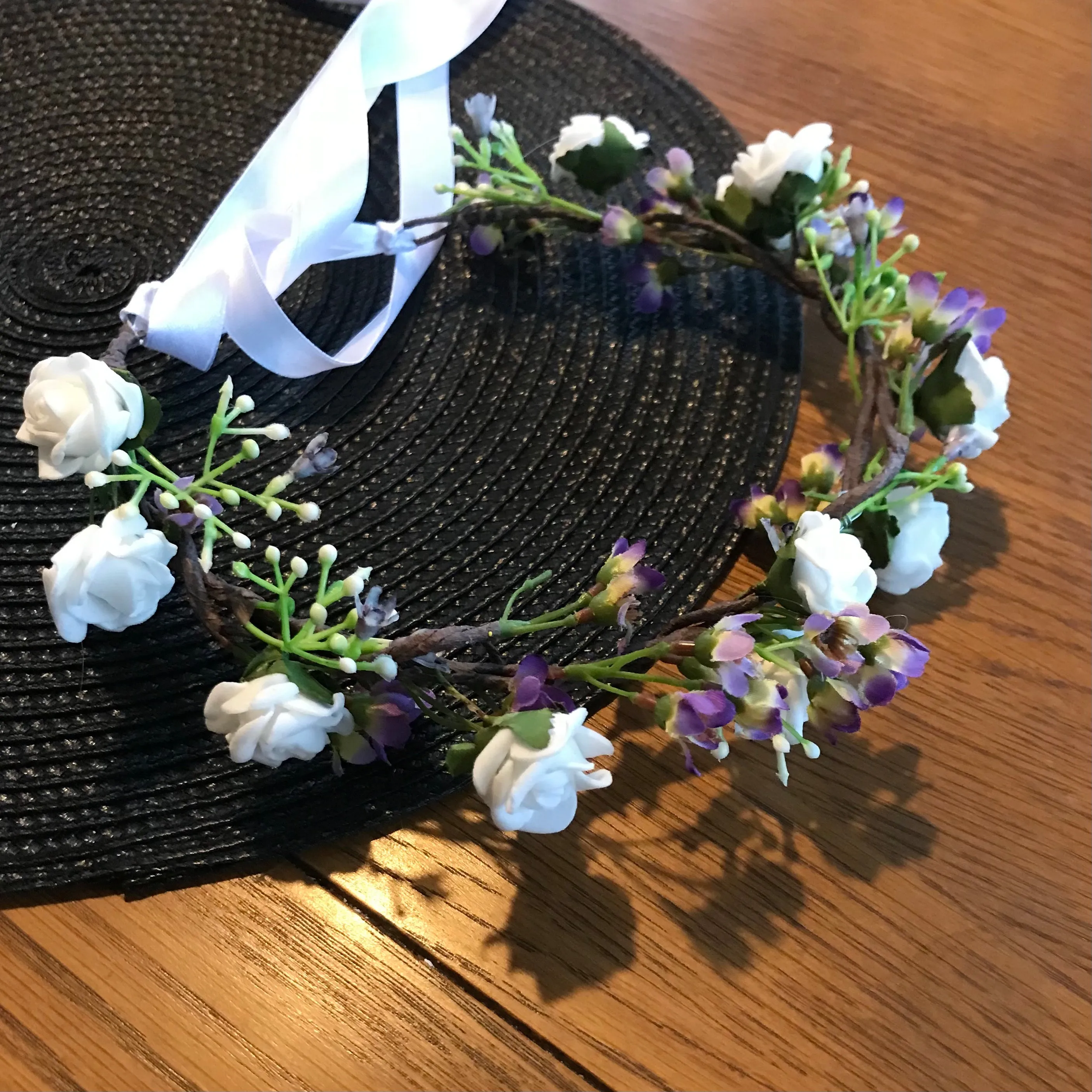 a flower crown of white and lilac artificial flowers